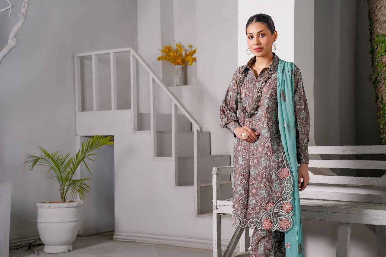 home-img Portrait of a South Asian woman in traditional attire posing indoors, showcasing elegant fashion.
